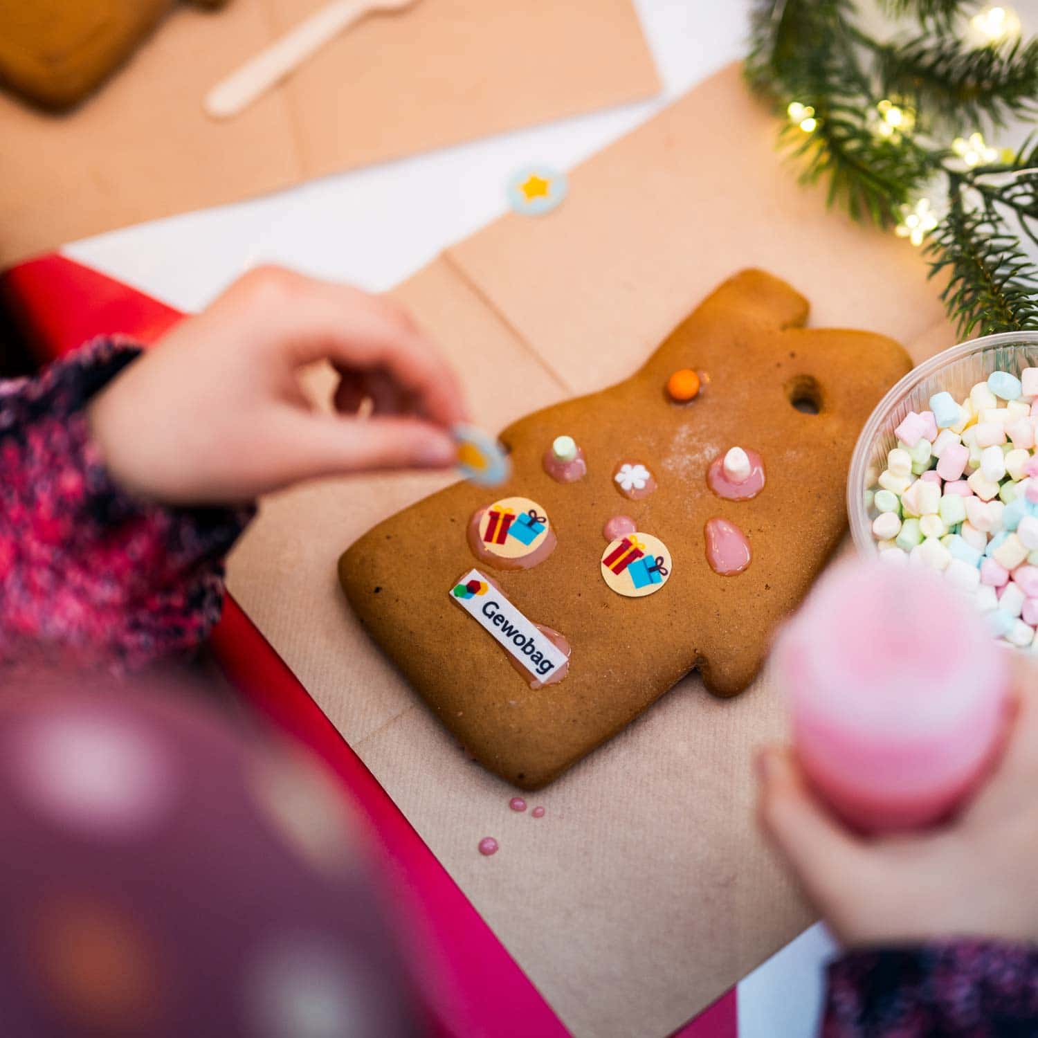Kind verziert einen Lebkuchen mit Gewobag-Logo bei einer Weihnachtsaktion